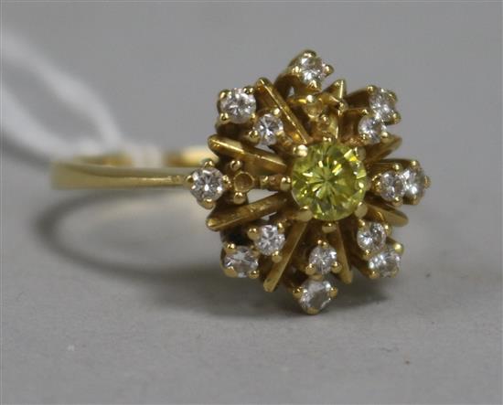 A fancy yellow and colourless diamond star-burst cluster ring, yellow metal shank (two small diamonds missing) size U.